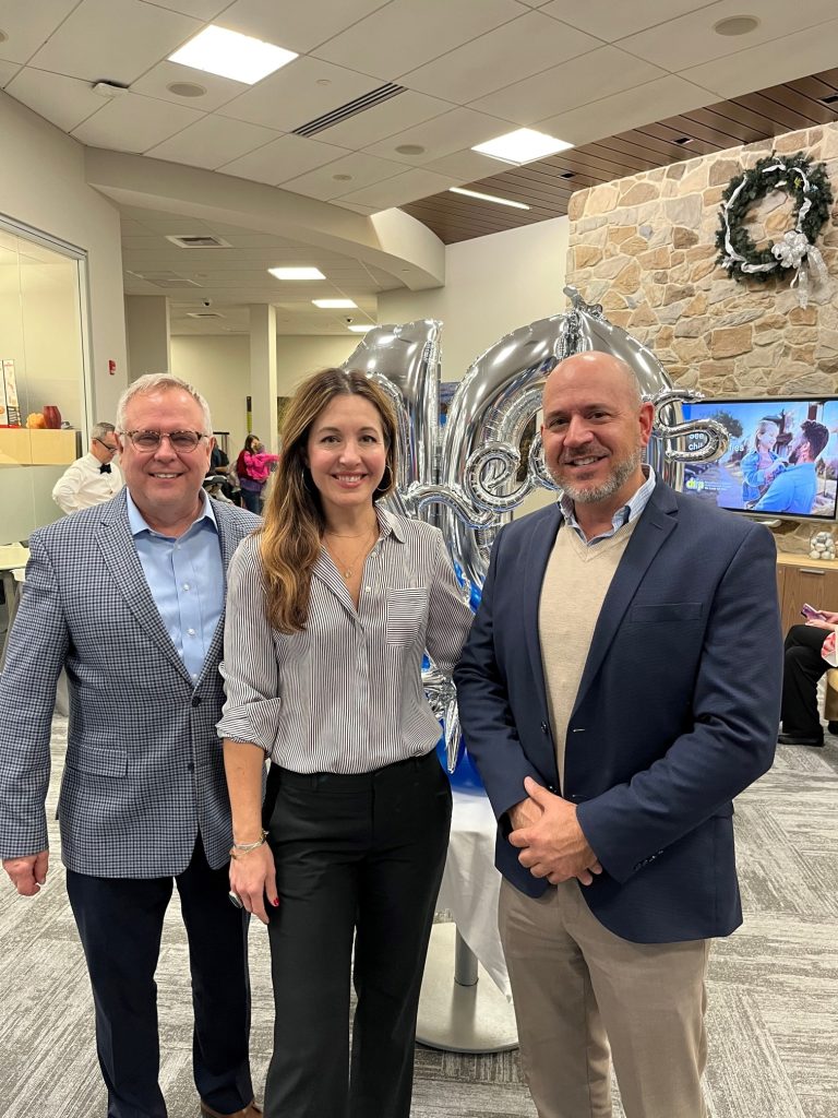 Capital Blue Cross Senior Vice President of Sales and Marketing Dave Skerpon, left, celebrates the 10th anniversary of the Saucon Valley Capital Blue Cross Connect Center on Wednesday with Capital colleagues Amanda Owens, vice president of brand and market strategy, and Mike Crnovic, director of retail services.