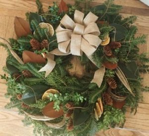 A wreath with a bow Description automatically generated