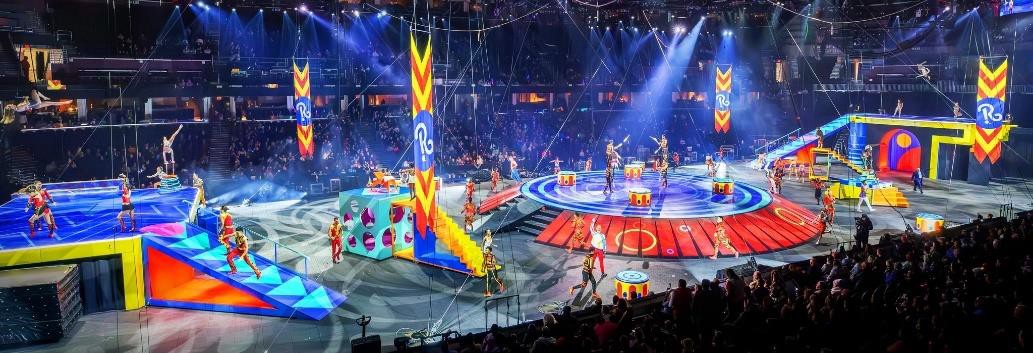 A circus arena with lights and people Description automatically generated